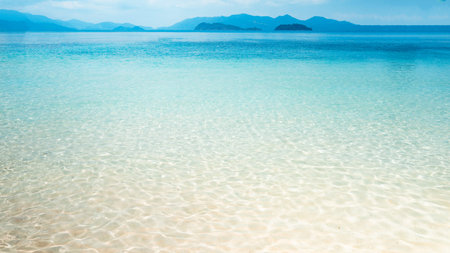 Clear water on the island,Bright blue sea and wooden boat