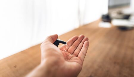 Alcohol gel cleaner,Preventing disease, Covid 19,Hand pressing sanitizer at workの写真素材