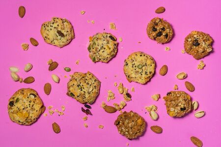 Cereal cookies and milk in a glass on a pink backgroundの写真素材