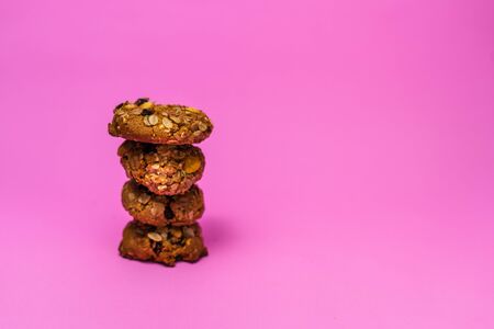Cereal cookies and milk in a glass on a pink backgroundの写真素材