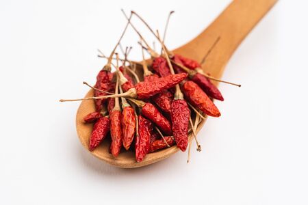 Paprika,spices,chili,Red peppers in a wooden spoon a white backgroundの写真素材