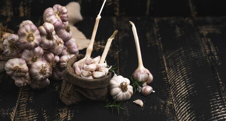 Close-up garlic on the black wooden background,Garlic spiceの写真素材