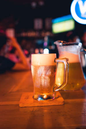 Beer poured into glasses in the barの写真素材