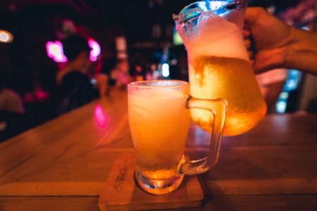 Beer poured into glasses in the barの写真素材