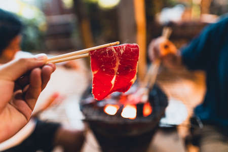 Beef slices grilled on the charcoal stove at homeの写真素材