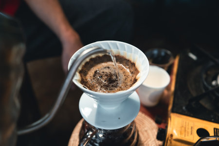 Drip coffee, barista pouring water on coffee ground with filter,brewing coffeeの写真素材