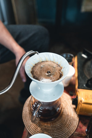 Drip coffee, barista pouring water on coffee ground with filter,brewing coffeeの写真素材