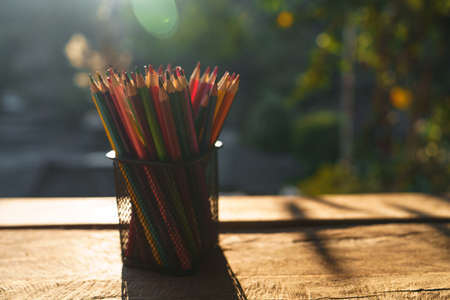 Colored pencils on the desk that are working outside the houseの写真素材