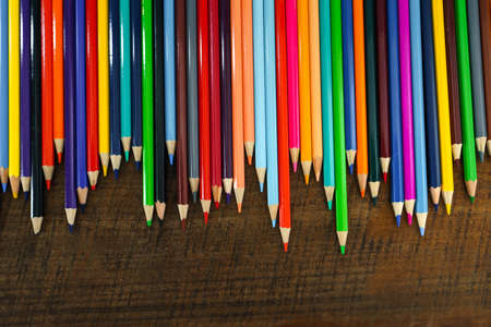 Colored pencils placed in front of the desk at homeの写真素材