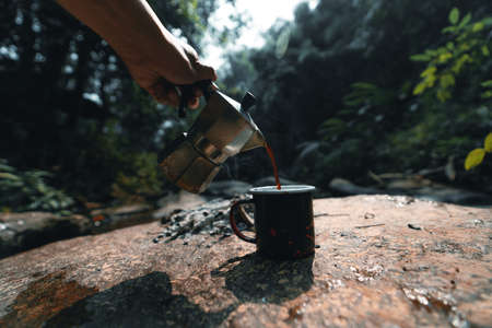 Brewing coffee in the forest with a moka pot in forestの写真素材