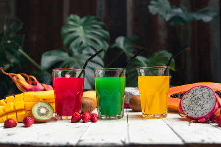 The computer and hands are working on the table with the coffee And trees at homeの写真素材