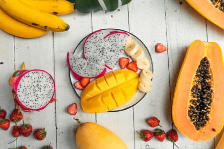 Ripe papaya on a wooden chopping board at the table Hot summerの写真素材