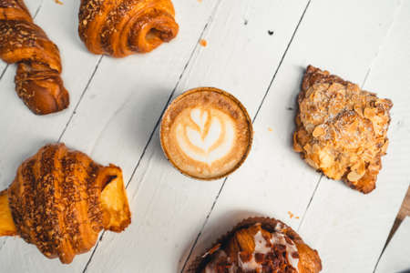 Freshly baked traditional bread on wooden table ,baked croissants in a bakeryの写真素材