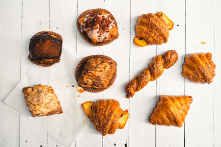Freshly baked traditional bread on wooden table ,baked croissants in a bakeryの写真素材