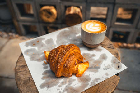 Freshly baked traditional bread on wooden table ,baked croissants in a bakeryの写真素材