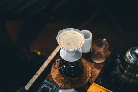 Drip coffee on a table in a coffee shop dark toneの写真素材