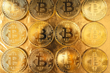 bitcoin coins stacked on black gold backgroundの写真素材