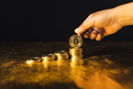 bitcoin coins stacked on black gold background