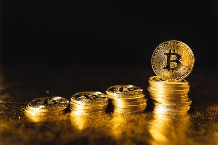 bitcoin coins stacked on black gold background