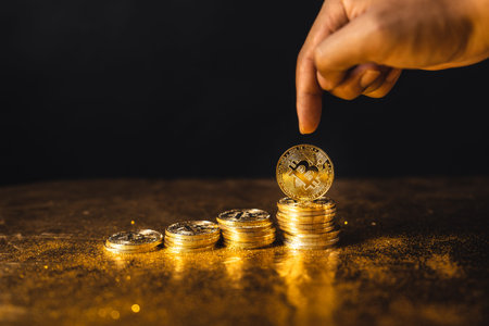 bitcoin coins stacked on black gold background