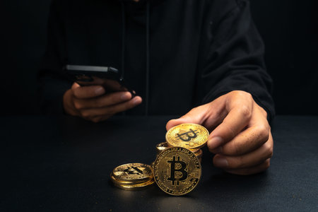 A golden bitcoin in the hand of a mysterious man,digital finance