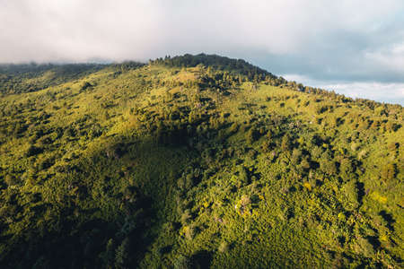 Sunset with clouds on the sky over mountain rangeの写真素材