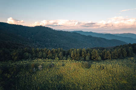 Sunset with clouds on the sky over mountain rangeの写真素材