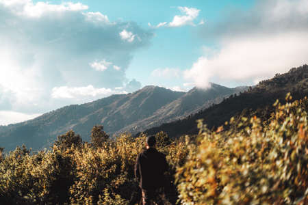 Sunset with clouds on the sky over mountain rangeの写真素材