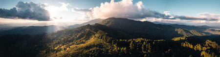 Sunset with clouds on the sky over mountain range