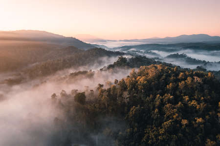 Flying above the clouds sunrise and fog,on the hillの写真素材