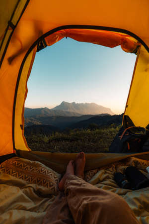 Yellow camping on the mountain, mountain view in the morningの写真素材