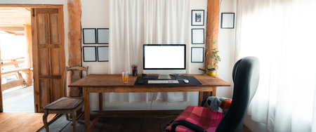 Computer screen on a wooden table in the houseの写真素材