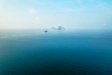 in the blue sea from above,boat and islandの写真素材