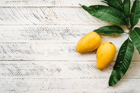 fresh yellow mango on white wood,の写真素材