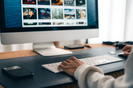 Man working on computer desk and smartphone at home officeの写真素材