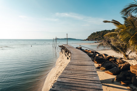 Wooden pier by the beach and clear blue water on Koh Koodの写真素材
