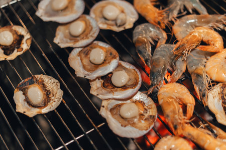 Scallops and shrimp grilled on a charcoal grill at the campsite.の写真素材