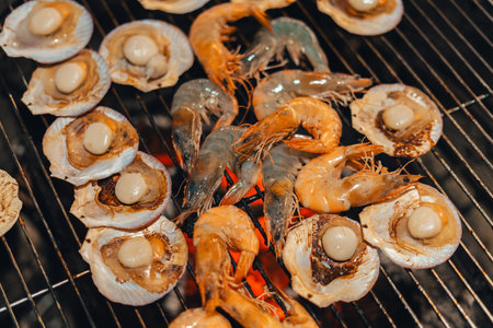Scallops and shrimp grilled on a charcoal grill at the campsite.の写真素材