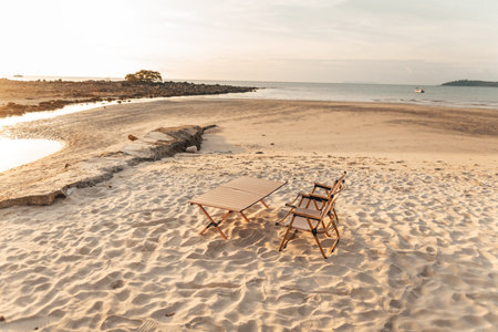Camping chairs on the beach in the evening Watch the sunsetの写真素材