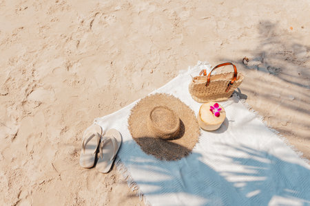 summer beach White cloth on the sand with coconut straw hat and bag,beachの写真素材