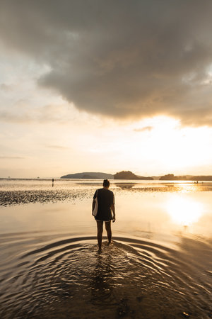 Woman walking on the beach in the evening,