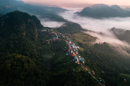 Morning fog and mountains with a rural village with sunrise from a high angle, Ban Jabo, Mae Hong...