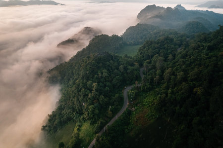 Morning fog and mountains as the sun rises from above