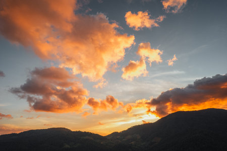 Golden clouds at dusk and mountains, evening clouds and sky background,