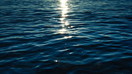 Backgrounds or marine themes,Dark ocean in early morning, dark blue waves with reflectionの写真素材