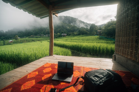Balcony at the cottage with rice field view and laptopの写真素材