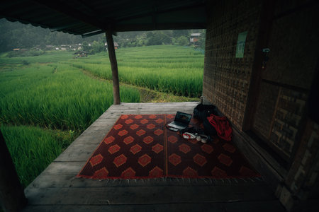 Balcony at the cottage with rice field view and laptop
