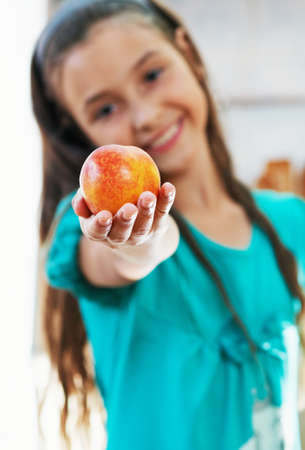 The beautiful girl is holding the appleの写真素材
