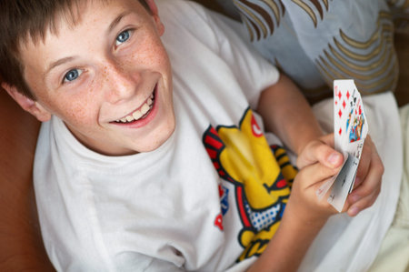 portrait of a smiling boy with cards