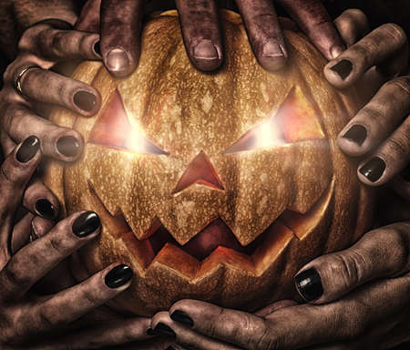 evil pumpkin with glowing eyes that are holding, closeupの写真素材